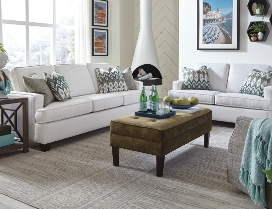 two light gray tight-backed sofas in a very light, airy, neutral living room
